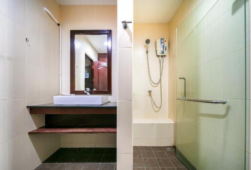 a bathroom with a shower and a sink at EBS Hostel Phuket in Ban Karon