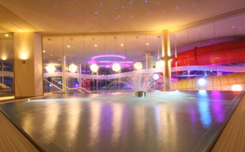 a fountain in the middle of a room with a building at Hotel Seehof in Walchsee