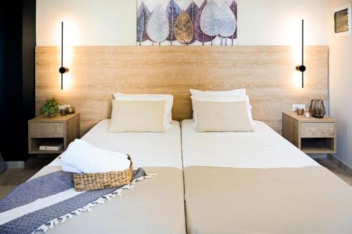 a bedroom with two beds and two night stands at Cozy Studio #5 in Malia