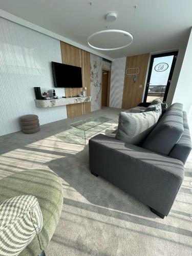 a living room with a couch and a glass table at Hotel Dolphin - Adult friendly in Senec