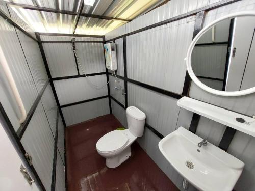 a small bathroom with a toilet and a sink at Ploy&Praew โดม 2 in Ban Sop Mae Klang