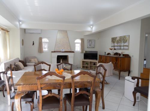 a living room with a table and a couch at Poulakis House in Asini