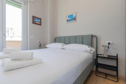 a bedroom with a large white bed and a window at I Host Apartment - Coni Zugna 58 in Milan