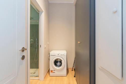 a laundry room with a washing machine and a washer at I Host Apartment - Coni Zugna 58 in Milan