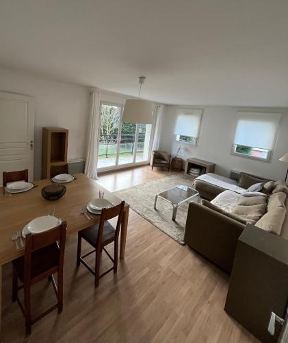 un salon avec un canapé et une table dans l'établissement Bright and spacious 2 bedroom with balcony, à Wasquehal