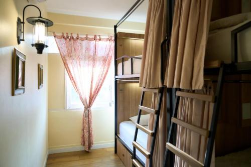 a room with bunk beds and a window at Lamoon Vivit in Bangkok