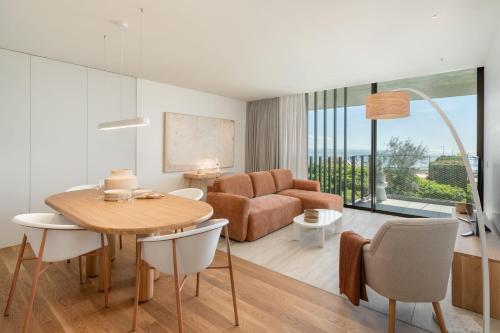 a living room with a table and a couch at Luxury in Funchal - Savoy Monumentalis II in Funchal