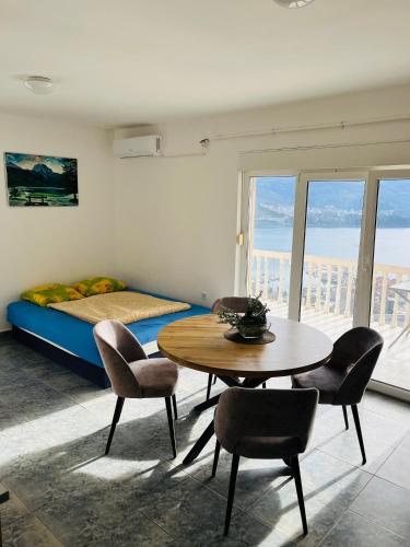a room with a table and chairs and a bed at TOP view Apartment Budva in Budva