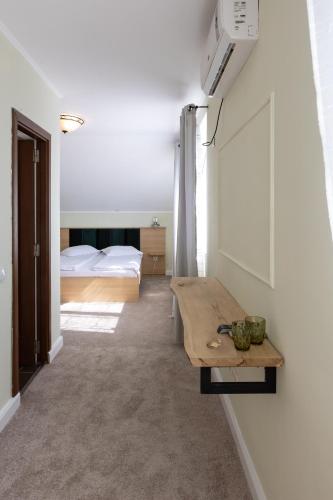 a living room with a table and a bedroom at Pension Bella Vista in Sighişoara