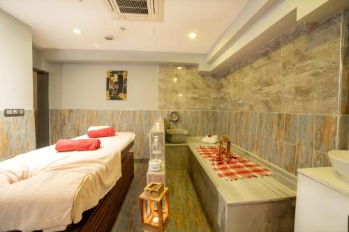 a bathroom with two beds and a bath tub at Royal Termal Hotel in Bursa