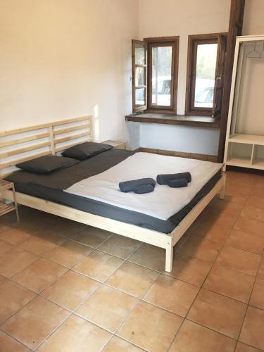 a bed in a room with two shoes on it at Reina's house by the sea in Akti Salonikiou