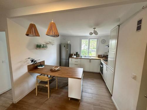 une cuisine avec une table en bois et un réfrigérateur dans l'établissement Apartment 4pers Saint Raphaël, à Saint-Raphaël
