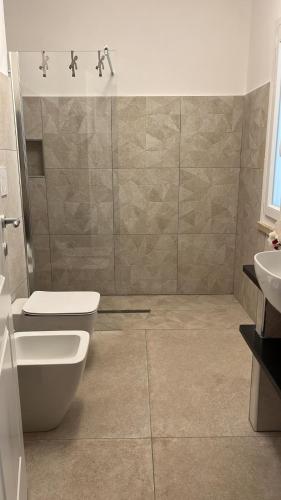 a bathroom with a toilet and a sink at L'Hermitage- Monte Argentario in Monte Argentario