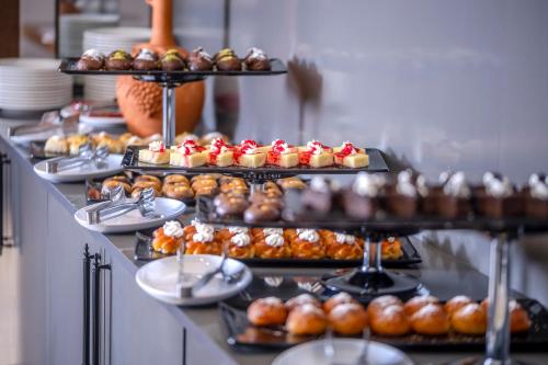 a buffet with many different types of pastries and donuts at Royal Termal Hotel in Bursa