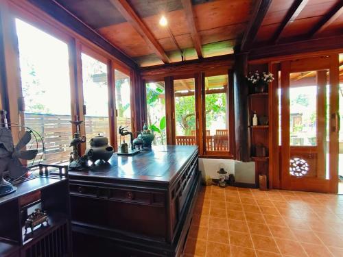 a kitchen with an island in a room with windows at Moc Homestay & Villa in Cư Chinh