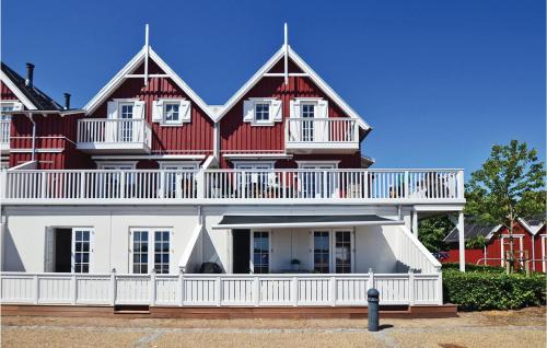 a large red and white house with a balcony at Two-Bedroom Apartment In Grasten in Gråsten