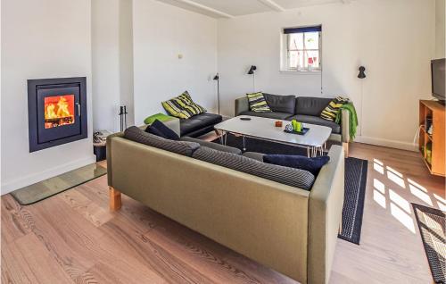 a living room with a couch and a fireplace at Two-Bedroom Apartment In Grasten in Gråsten