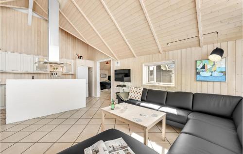 a living room with a couch and a table at Holiday Home Gloryvej Harboøre Iv in Harboør