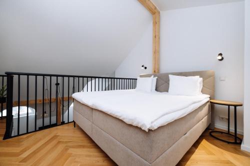 a bedroom with a large bed with white sheets at Hestia Apartments Barons in Tallinn