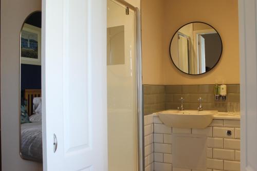 a bathroom with a sink and a mirror at The Old Buoy Inn in Seahouses