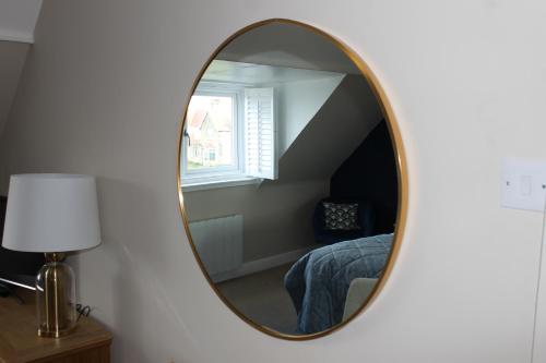 a mirror in a room with a bed and a window at The Old Buoy Inn in Seahouses