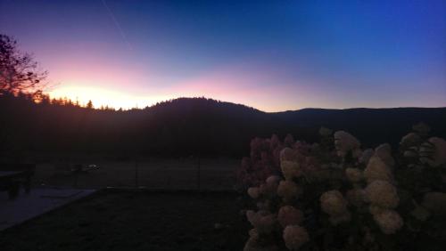 a sunset from the backyard of a house at La Ferme Du Levant in Gérardmer