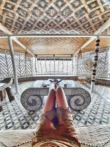 a person with their feet up in a room at Villa Tua, Beach Pool & Spa in Letman