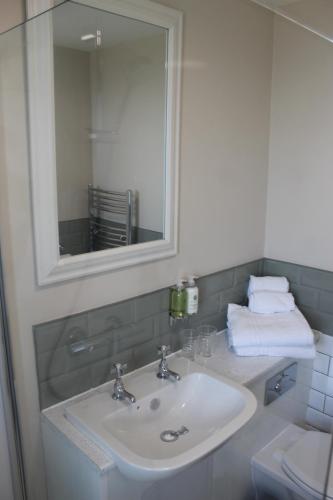 a bathroom with a sink and a mirror at The Old Buoy Inn in Seahouses