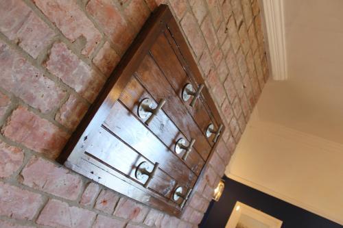 a wooden cabinet on a brick wall at The Old Buoy Inn in Seahouses