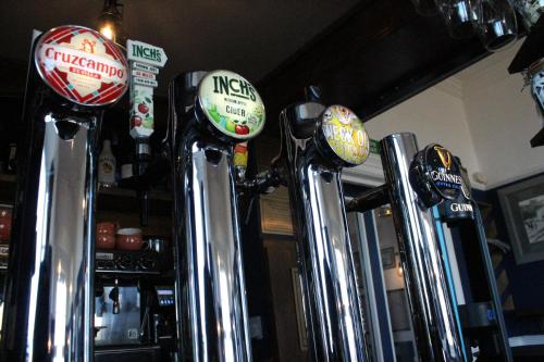 a row of soda machines in a bar at The Old Buoy Inn in Seahouses