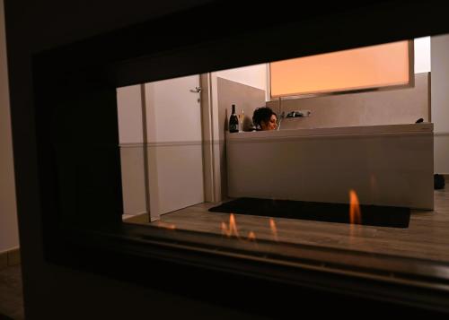 a reflection of a person in a bathroom mirror at The Place in Cutrofiano