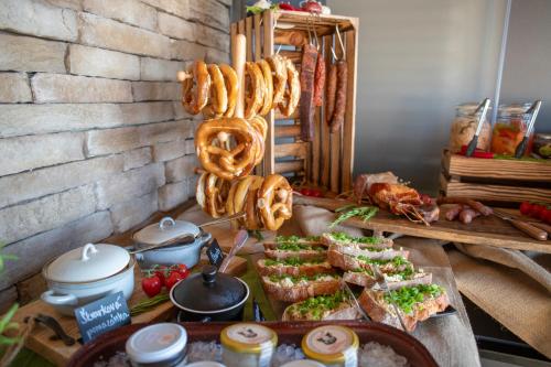 a buffet with sandwiches and pretzels and other food at Amenity Hotel & Resort Lipno in Lipno nad Vltavou