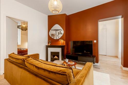 un salon avec un canapé et une télévision dans l'établissement B21#République#Marais#3BedRooms#Paris03#Air-conditioning, à Paris