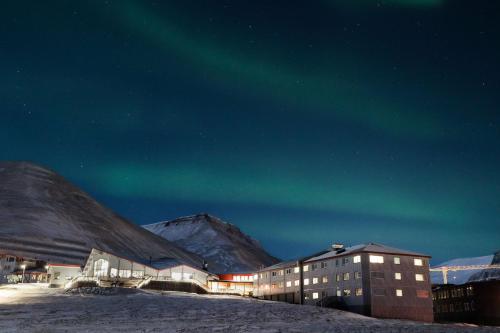 an apartment building with the aurora in the sky at Radisson Blu Polar Hotel, Spitsbergen in Longyearbyen