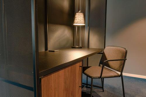 a desk with a chair and a lamp in a room at Radisson Blu Polar Hotel, Spitsbergen in Longyearbyen