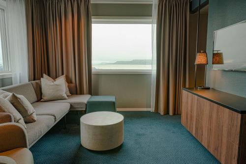 a living room with a couch and a table at Radisson Blu Polar Hotel, Spitsbergen in Longyearbyen