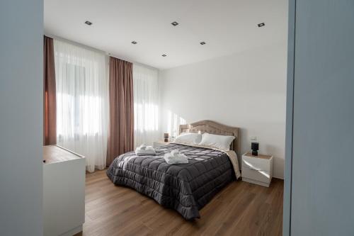 a bedroom with a bed and a large window at Home One Room Verona Fiera with private bathroom in Verona