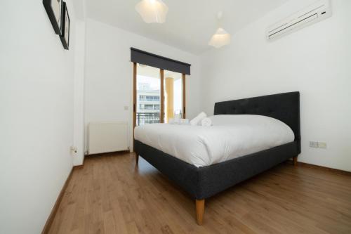 een slaapkamer met een bed met een zwart hoofdeinde bij 1 bedroom flat in city center in Nicosia
