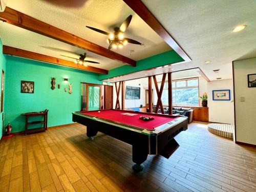 a pool table in a room with green walls at Sunset Villa Shirahama 5 min to the beach Pets OK in Shimoda