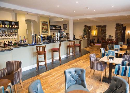 a bar in a restaurant with chairs and tables at Atlantic Reach Holiday Village in Newquay