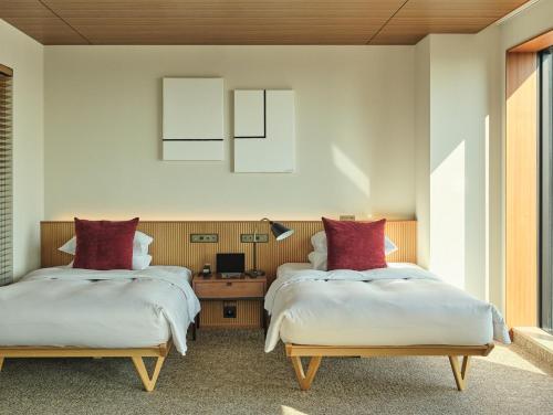 Postel nebo postele na pokoji v ubytování THE AOYAMA GRAND HOTEL