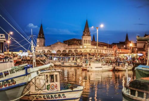 a group of boats docked in a marina at night at Pousada Recanto do Sabiá in Barcarena