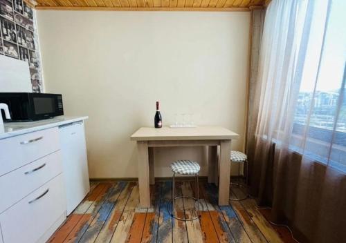a table with a bottle of wine on it in a kitchen at VeraNda in Tbilisi City
