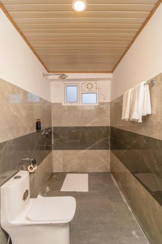 a bathroom with a toilet and a shower at Divine The Celeste, Pelling in Pelling
