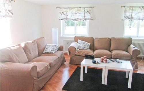 a living room with a couch and a coffee table at Lovely Home In Bolmsö With Sauna in Bolmsö