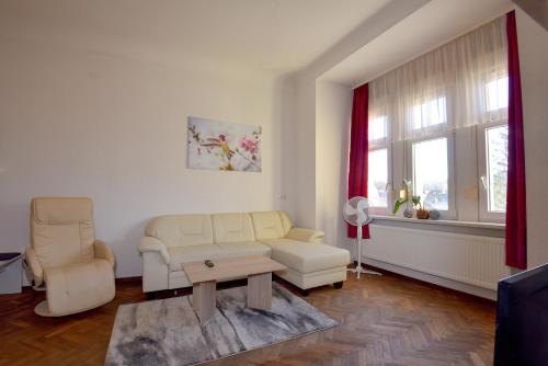 a living room with a couch and a table at Parkvilla Köhler in Zella-Mehlis