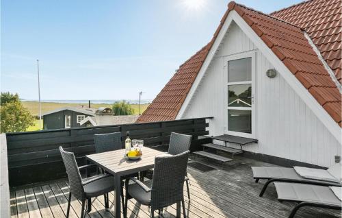 a patio with a table and chairs on a roof at Holiday Home Sønderbygade V in Kegnæshøj