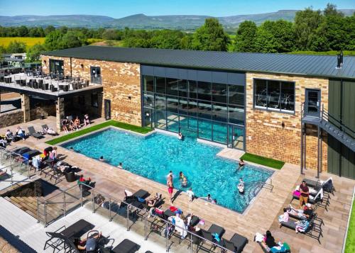 an overhead view of a swimming pool in a building at Wild Rose Holiday Park in Colby