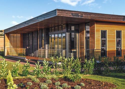 a wooden house with a garden in front of it at Goosedale Lodges in Nottingham