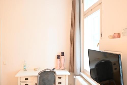 a living room with a flat screen tv next to a window at Landsitzhotel und Seminarium Peterhof in Hodorf